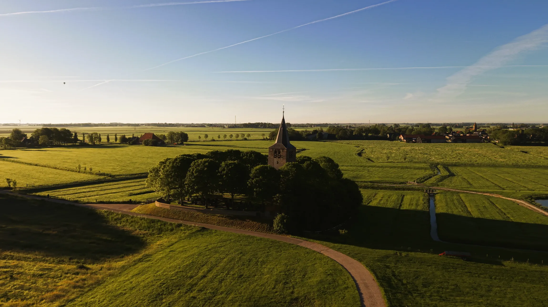 De Ald Toer op de terp tussen de Friese weilanden in het gouden uur